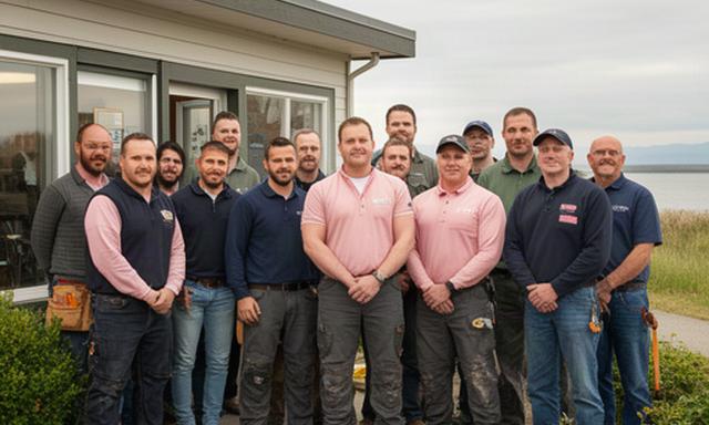 Licensed electricians, plumbers, and HVAC technicians standing together outside the Boundary Bay Dyke Trail office in Delta